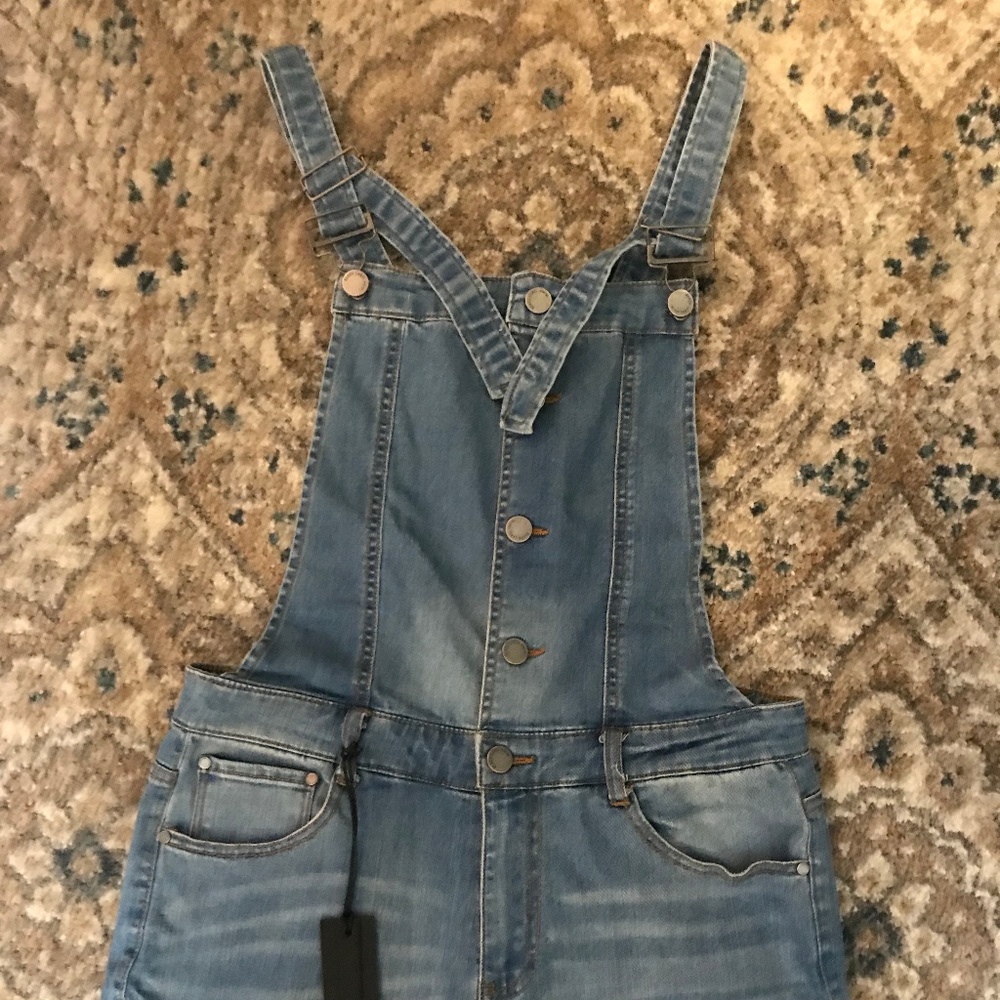 Distressed blue jean overall